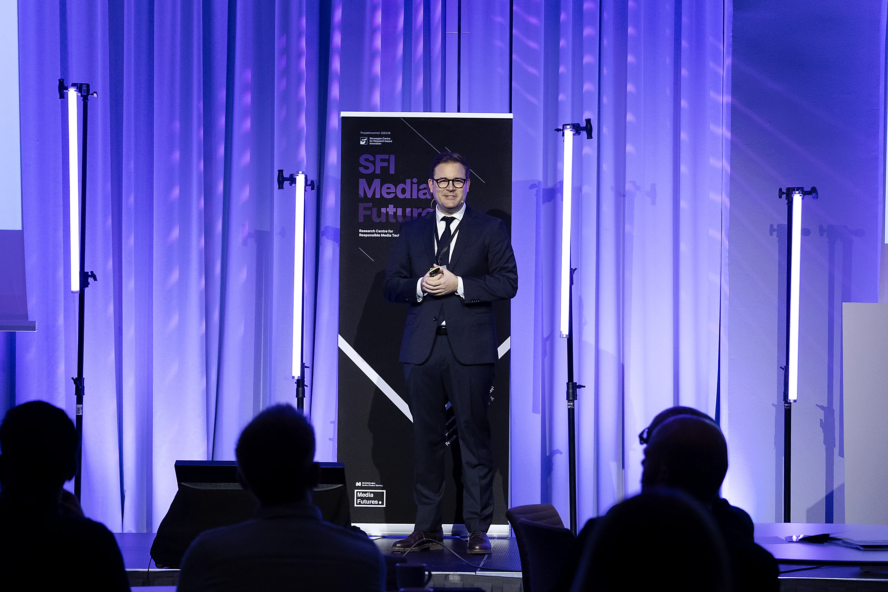Full-stage photo of Christoph Trattner giving a talk at MediaFutures.